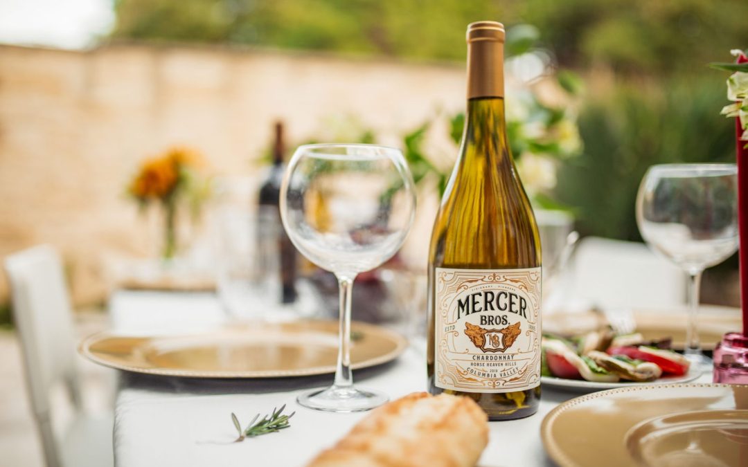 table set up with empty wine glass and a bottle of wine