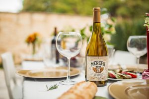 table set up with empty wine glass and a bottle of wine